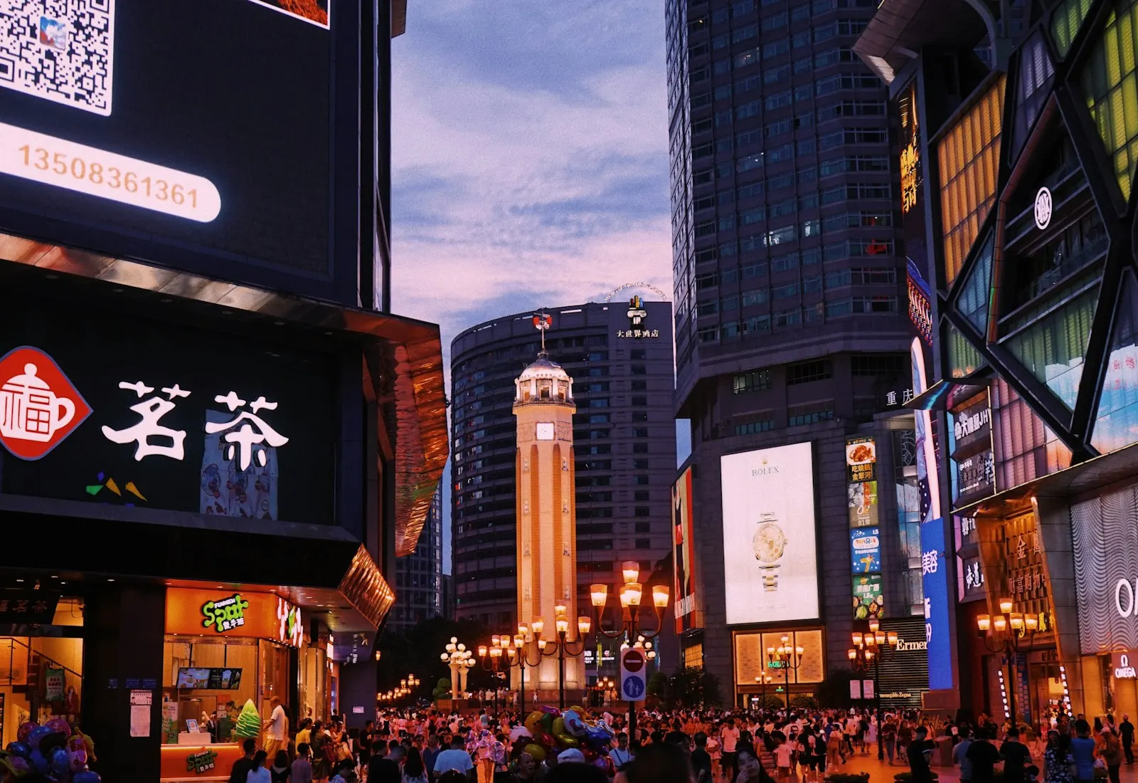 Crowds and illuminated high-rise buildings in Chongqing at night
